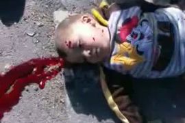 This image grab of footage uploaded on YouTube on March 20, 2012, allegedly shows a child on the ground, one of three people shot in the al-Khalidiya neighbourhood of restive central city of Homs. The UN Security Council was to weigh a draft statement warning Syria of "further measures" if it fails to cooperate with peace envoy Kofi Annan, a