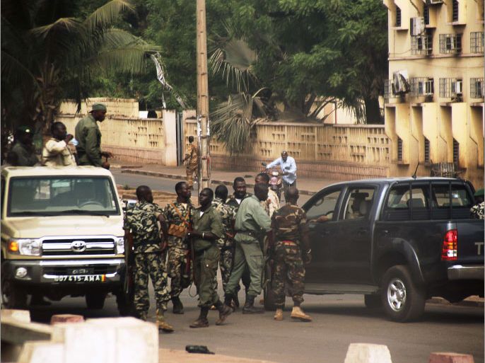 Malian soldiers gather on a street of Bamako on March 21, 2012. Scores of Malian soldiers mutinied today, firing shots in the air and seizing the state broadcaster amid fury over their poorly-equipped efforts to stamp out a Tuareg insurgency in the north. Dozens of soldiers created panic on the streets of Bamako, with people running in all directions as they shot wildly before occupying the Malian Radio-Television Office (ORTM) around 1630 GMT, also firing off rounds inside the building. AFP PHOTO / HABIBOU KOUYATE