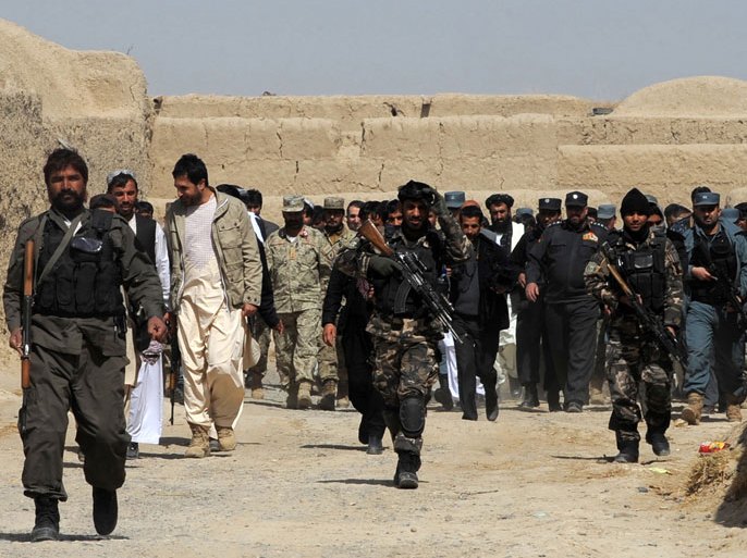 An Afghan delegation walk swith locals after a gathering for a memorial ceremony at Mohammad mosque in Alokozai village of Pajwai district in Kandahar province on March 13, 2012. Gunmen on Tuesday attacked an Afghan memorial service for 16 villagers killed by a US soldier, shooting dead a member of the Afghan military and wounding a policeman in a hail of gunfire. It was the first deadly violence linked to the aftermath of Sunday's killings that the Taliban had vowed to avenge and US officials had warned could lead to a surge in anti-American violence in the war-torn country. AFP PHOTO/ JANGIR