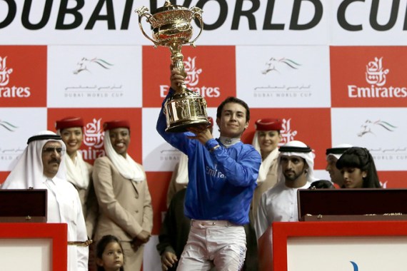 French jockey Mickael Barzalona raises the trophy after leading Monterosso to win the Dubai World Cup race at the Meydan track in the Gulf emirate on March 31, 2012. AFP