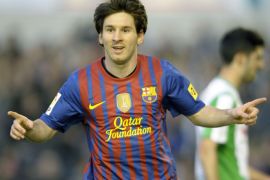 MR1627 - Santander, -, SPAIN : FC Barcelona's Argentinian forward Lionel Messi celebrates after scoring a goal during the Spanish league football match Racing vs Barcelona, on March 11, 2012, at El Sardinero Stadium in Santander. Barcelona won the match 2-0. AFP PHOTO/ MIGUEL RIOPA
