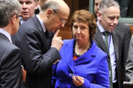 French Foreign Affairs minister Alain Juppe (L) talks on March 23, 2012 with EU foreign policy chief Catherine Ashton prior to the start of a Foreign Affairs Council at the EU Headquarters in Brussels. EU foreign ministers were set on March 23 to slap