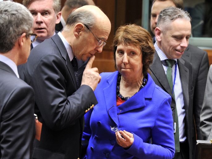 French Foreign Affairs minister Alain Juppe (L) talks on March 23, 2012 with EU foreign policy chief Catherine Ashton prior to the start of a Foreign Affairs Council at the EU Headquarters in Brussels. EU foreign ministers were set on March 23 to slap