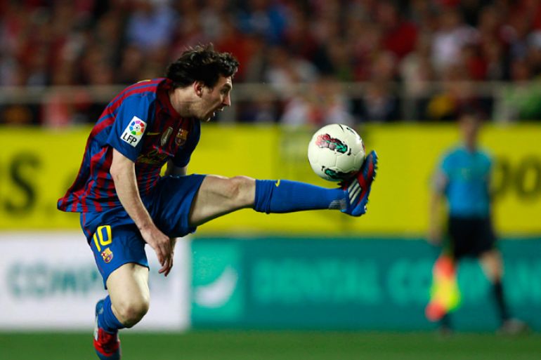 Barcelona's Lionel Messi jumps as he controls the ball during their Spanish First Division soccer match against Sevilla at Ramon Sanchez Pizjuan stadium in Seville March 17, 2012.