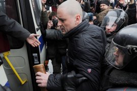 Russian riot policemen detain an opposition Left Front movement leader, Sergei Udaltsov, during the demonstration outside Ostankino tower which aims to cap a growing campaign for Russians to boycott NTV television, in Moscow on March