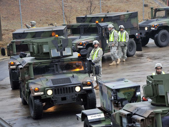 US military vehicles are driven onto a train during a railhead operation of prepositioned equipment at Camp Carroll in Chilgok, 220 kms southeast of Seoul, on March 6, 2012. The drill is part of the annual Key Resolve/Foal Eagle military exercises by the US and South Korea.