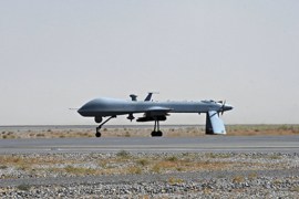 A US Predator unmanned drone armed with a missile stands on the tarmac of Kandahar military airport on June 13, 2010. Afghan President Hamid Karzai appealed to hundreds of tribal and religious leaders to support a major operation in their southern province, the heartland of a Taliban insurgency. Karzai, accompanied by top NATO commander US General Stanley McChrystal, spoke to representatives and residents in Kandahar about renewed efforts to bring stability to the war-weary province. AFP PHOTO/Massoud HOSSAINI/POOL