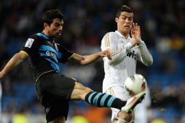 Real Madrid's Portuguese forward Cristiano Ronaldo (R) fights for the ball with Espanyol's defender Jordi Amat Maas on March 4, 2012