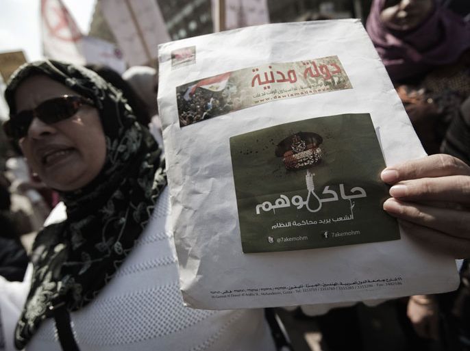 An Egyptian woman holds an anti SCAF (Supreme Council of Armed Forces), during a demonstration outside the administrative court in the capital Cairo on March 27, 2012, to call for the constitution drafting panel to be made up entirely of non-parliamentarians