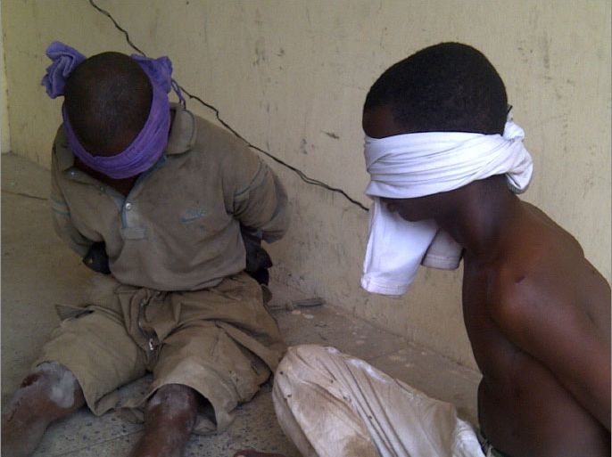 Men suspected to be members of Islamic sect Boko Haram sit blindfolded at a barrack after a shootout between the sect and the military in Nigeria's northern city of Kano March 20, 2012. Operatives of a joint task force (JTF) from the military shot dead 9 gunmen suspected to be members of the Boko Haram Islamic sect at Tudun Wada. Picture taken March 20, 2012. REUTERS/Bala Adamu (NIGERIA - Tags: POLITICS RELIGION CIVIL UNREST)