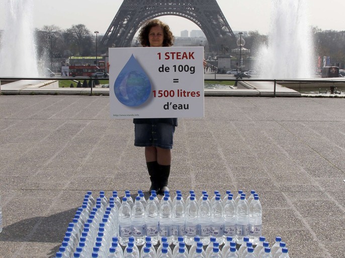 A thousand 1.5 liter bottles of water with blue caps are displayed by members of the collectif Viande.info (meat group-info), to form the word one steak, near the Eiffel tower in Paris, on March 22, 2012, as part the World Water Day. The group, which evaluates the impact of livestock and fisheries on humans, animals and the environment, says that a 100-gram steak requires 1,500 liters of water to produce, while 100 grams of wheat only need 150 liters of water to grow.