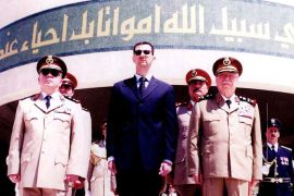 Syrian President Bashar Assad, center, Defense Minister Mustafa Tlass, right, and Chief of Staff Hassan Turkmani stand solemnly in front of the Edifice of Martyr on Tuesday, May 6th, 2003 in Damascus to mark the 88th anniversary of the execution of 800 Syrian fighters for independence from the Ottomans rule. The execution by Jamal Pasha, the Ottoman governer of Syria in 1915, took place at the famous al-Marja Square.
