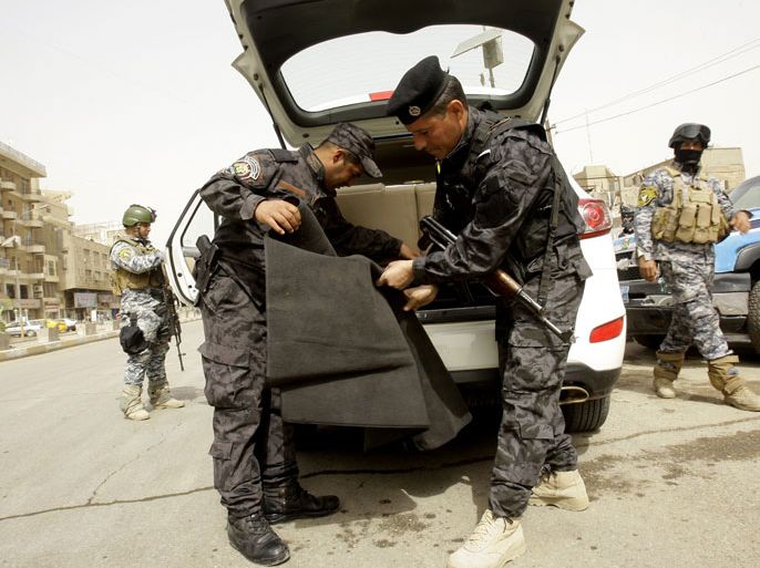 raqi security forces set search a car at one of several checkpoints on streets leading to the heavily fortified Green Zone in Baghdad on March 27, 2012