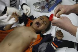 A wounded Palestinian child is checked by doctors at a hospital in Beit Lahia in the northern Gaza Strip, on March 11, 2012