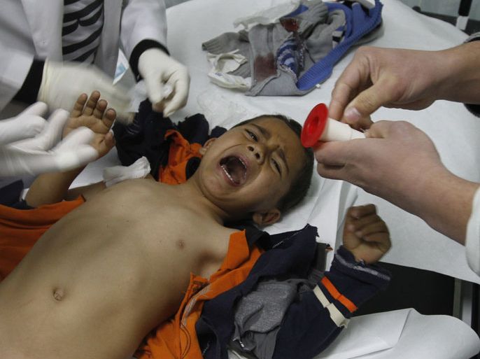 A wounded Palestinian child is checked by doctors at a hospital in Beit Lahia in the northern Gaza Strip, on March 11, 2012