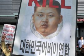 An anti-North Korean campaigner holds a banner denouncing the North's leader Kim Jong-Un during a protest against Pyongyang's recent threat to attack the South Korean capital, in Seoul on April 26, 2012. South Korea is seeking to extend United Nations sanctions to 19 more North Korean institutions following the country's widely condemned rocket launch this month, a report said April 26. AFP PHOTO / KIM JAE-HWAN