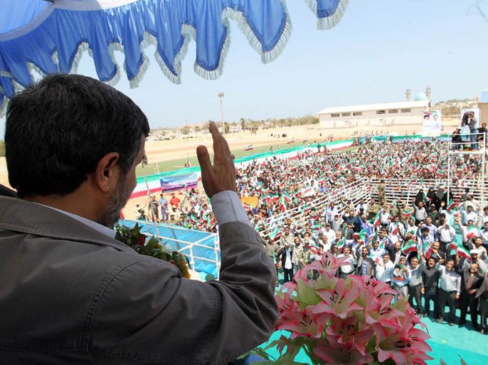 A handout picture released by Iranian President Mahmoud Ahmadinejad's official website shows Ahmadinejad waving at supporters during a visit to island of Abu Musa on April 11, 2012.