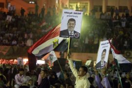 Supporters of Mohammed Mursi (poster), Egyptian head of the Muslim Brotherhood's Freedom and Justice Party and presidential candidate, attend his election campaign rally in a football stadium in Zagazig city, some 90 kms (56 miles) northeast of Cairo, on April 23, 2012. AFP