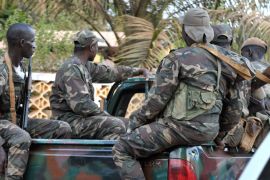 Militarymen sit in a pickup after a meeting with opposition parties on April 15, 2012 in Bissau. The army and opposition parties in Guinea-Bissau are to dissolve all existing institutions and set up a National Transitional Council, a spokesman for the parties said. AFP PHOTO/ SEYLLOU