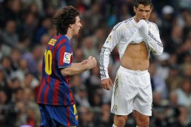 MADRID, SPAIN - APRIL 10: Lionel Messi (L) of FC Barcelona clenches his fists celebrating scoring his sides opening goal as Cristiano Ronaldo of Real Madrid reacts during the La Liga match between Real Madrid and Barcelona at the Estadio Santiago Bernabeu on April 10, 2010 in Madrid, Spain. Barcelona won the match 2-0. (Photo by Jasper Juinen/Getty Images)