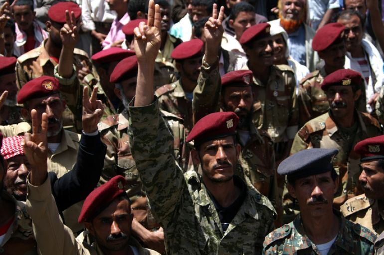 Members of the Yemeni army flash the sign for victory during a sit-in demanding for the dismissal of former leader Ali Abdullah Saleh's relatives that remain in powerful military posts, in Sanaa on April 16, 2012 . AFP
