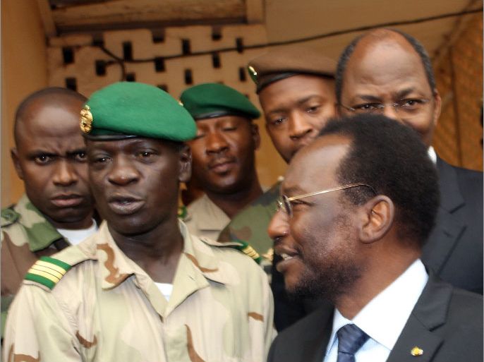 Mali's speaker of parliament Dioncounda Traore (R, with glasses) stands next to Captain Amadou Sanogo (2nd L) after they met on April 9, 2012 at the Kati military barracks outside Bamako. The man overseeing Mali's return to democratic rule met Monday with the army captain who seized power with other soldiers on March 22. Dioncounda Traore, who is Mali's speaker of parliament and will be the interim president under a power transfer deal agreed Friday, arrived at a military camp near the capital Bamako to meet with Captain Amadou Sanogo. (background R is Burkina Faso's Foreign Minister Djibrill Bassole). AFP PHOTO / HABIBOU KOUYATE