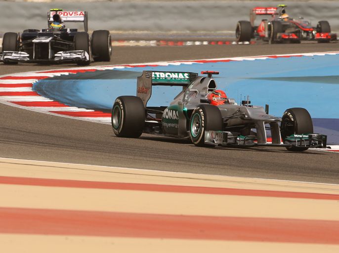 (L to R) McLaren Mercedes' British driver Lewis Hamilton, Williams' Brazilian driver Bruno Sena and Mercedes' German driver Michael Schumacher drive on April 21, 2012 during the qualifing session at the Bahrain international circuit in Manama ahead of the Bahrain Formula One Grand Prix. AFP