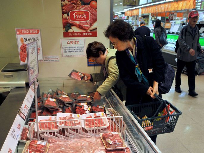 South Korean customers look at selections of local beef at a Lotte Mart as the store suspended sales of all US beef in Seoul on April 25, 2012. Two major South Korean retailers suspended sales of US beef after a new case of mad cow disease in California, and the government said it would tighten inspection of imports. AFP PHOTO / JUNG YEON-JE
