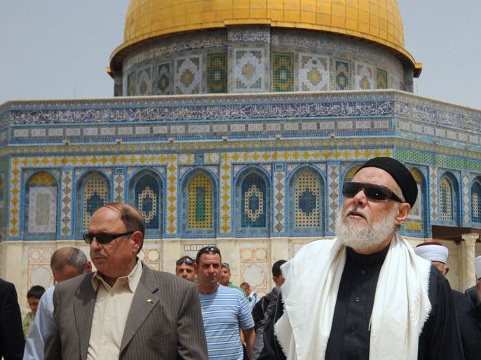 Egyptian Grand Mufti Ali Gomaa (R) walks out of Jerusalem's Dome of the Rock mosque during his visit to the Al-Aqsa mosques compound, Islam's third holiest site, on April 18, 2012. The mufti's visit to Jerusalem caused a stir on Apri l 19 in his own country, where normalisation of ties with Israel remains a highly sensitive issu despite Egypt being the first Arab country to sign a peace treaty with Israel, in 1979. AFP PHOTO/STR -- CROPPED VERSION / ISRAEL OUT --
