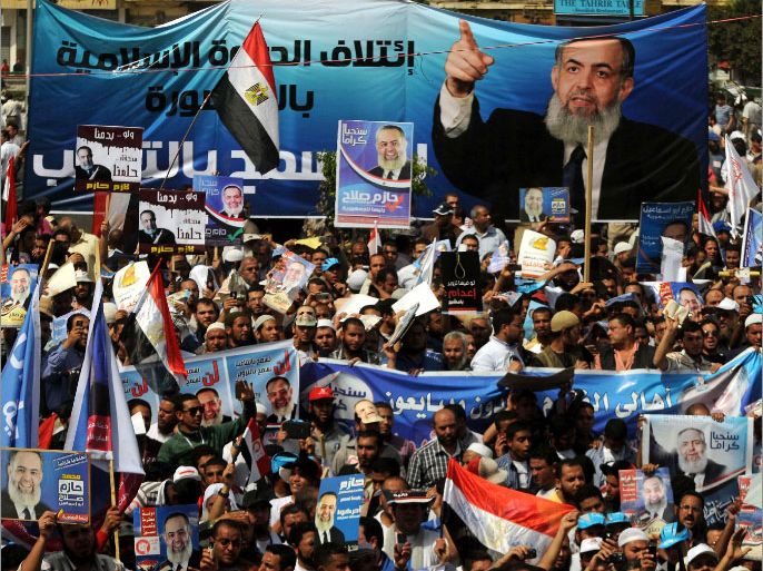 Supporters of Egyptian Salafist candidate Hazem Abu Ismail hold his posters at Tahrir Square in Cairo on April 6, 2012 during a protest against a potential decision to rule him out of Egypt's presidential election because his mother reportedly held US nationality. Under the country's electoral law, all candidates for the presidency, their parents and their wives must have only Egyptian citizenship. AFP PHOTO/MOHAMMED HOSSAM