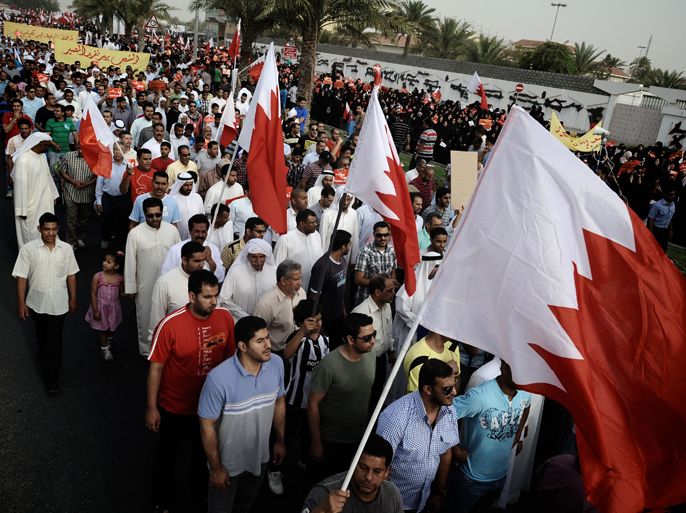 Bahraini protesters hold their national flags during a demonstration in a Shiite suburb of the capital Manama, on April 20, 2012 to demand a halt to the Formula One Grand Prix event. Bahrain's rulers insisted this weekend's Grand Prix must go ahead to avoid "empowering extremists" after the Gulf kingdom was rocked by fresh violence and the Force India team pulled out of a practice session. AFP