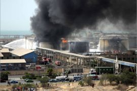 epa03183621 A general view shows black smoke rising from oil containers at the Nasr Petroleum Company refinery, in Suez, Egypt, 15 April 2012. According to local media reports on 15 April, the blaze burned for 18 hours causing the death of one worker and injuring 24 others. Egyptian Petroleum Minister said a technical team has been charged to investigate the cause of the fire. EPA/STR