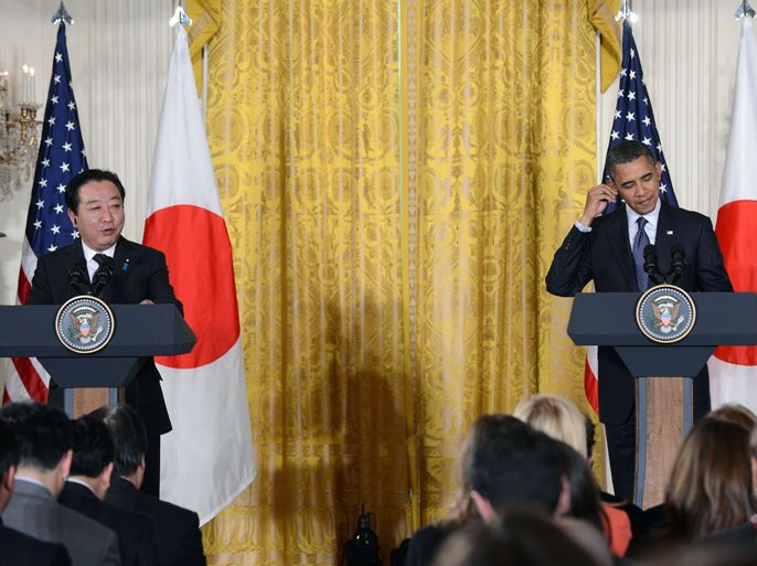 US President Barack Obama (R) adjusts his headphone as Japan's Prime Minister Yoshihiko Noda speaks during a joint press conference in the East Room at the White House in Washington, DC, on April 30, 2012. The two leaders met amid fears that North Korea will test another nuclear bomb following its failed missile test and with concerns rippling through the Asia-Pacific region about the implications of China's geopolitical rise. Noda is the first Japanese premier to visit Washington for a solely bilateral visit since the 2009 election of his center-left Democratic Party of Japan sent long-stable relations into a tailspin. AFP