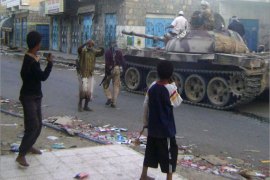 Yemeni armed tribesmen, supported by the Yemeni army to fight with Al-Qaeda militants, ride a tank in the southern town of Loder in Abyan province on April 14, 2012. According to the local sources, clashes between Yemeni armed civilians and Al-Qaeda militants trying to retake control of the town of Loder spread to nearby Mudia, as the death toll from four days of clashes reached 200. AFP PHOTO/STR