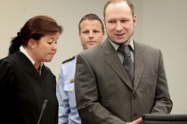 Norwegian 33-year-old right wing extremist Anders Behring Breivik smiles as he arrives with his lawyer Vibeke Hein Baera in Oslo's courtroom on April 25, 2012 during his trial for having killed 77 people last July. Breivik has been charged with "acts of terror" and faces either 21 years in prison, a sentence that could be extended indefinitely if he is still considered a threat to society, or closed psychiatric care, possibly for life. AFP PHOTO / POOL /Hakon Mosvold Larsen