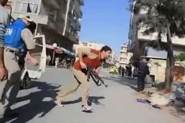 An image grab taken from a video uploaded on youtube on April 21, 2012 purpordely shows an armed Syrian man jumpimg out of a truck as a UN observer looks on in Homs province. The United Nations voted to send 300 unarmed ceasefire observers to Syria, but the United States warned it may veto a new mandate for the force because its patience was "exhausted." AFP