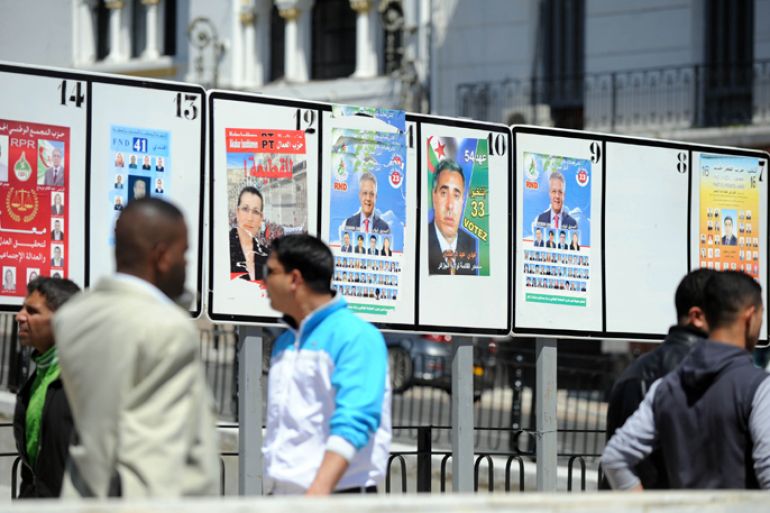 People walk past candidate's posters for the May 10 legislative elections in Algiers on April 21, 2012. The campaign began this week for polls President Abdelaziz Bouteflika's regime bills as part of an unprecedented reform process and come amid deep political upheaval in most of Algeria's neighbouring states. AFP