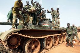 epa03193947 Sudanese soldiers pose on a tank during their celebration in Heglig, Sudan, 23 April 2012. The European Union on 23 April urged Sudan and South Sudan to stop their escalating conflict, as France warned that the bloc might resort to sanctions to pressure the two sides into ceasing hostilities. They urged South Sudan to make good on promises to withdraw from the disputed Heglig oil fields and on Sudan to stop air raids on South Sudanese territory. EPA/STR