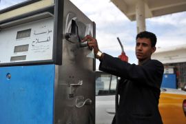 epa03169788 A Yemeni worker prepares to fill a vehicle with fuel at a petrol