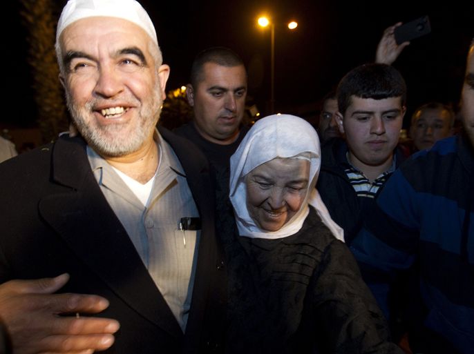 Arab-Israeli Islamist leader Sheikh Raed Salah (L) is welcomed by his mother Rokaia (C) and hundreds of supporters, at Ben Gurion airport near Tel Aviv on April 16, 2012. Salah, the leader of the radical wing of the Islamic Movement in Israel, was detained in London on charge of entering the country illegally and he now faces deportation from Britain.