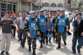 A handout picture released by the Syrian Arab News Agency (SANA) shows Moroccan advance team leader Colonel Ahmed Himmiche (C- left), a member of a UN monitors team tasked with monitoring the UN-backed ceasefire in Syria, and two other UN monitors as they visit a suburb of the Syrian capital Damascus on April 18, 2012. UN observers have acknowledged that they face a tough task to firm up a ceasefire in Syria, as seven civilians were killed Tuesday in the latest violence on the sixth day of a tenuous truce.  AFP PHOTO/HO  -- RESTRICTED TO EDITORIAL USE - MANDATORY CREDIT "AFP PHOTO / HO / SANA" - NO MARKETING NO ADVERTISING CAMPAIGNS - DISTRIBUTED AS A SERVICE TO CLIENTS