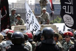 Soldiers stand on a military vehicle next to a Salafist flag as supporters of Salafist leader and former presidential candidate Hazem Salah Abu Ismail and other political parties protest outside the Egyptian military council in Cairo April 28, 2012. Egyptians marched on the country's defence ministry to demand that the Presidential Election commission be dissolved after it upheld a ban on two Islamist presidential candidates and allowed Hosni Mubarak's former Prime Minister to run. REUTERS