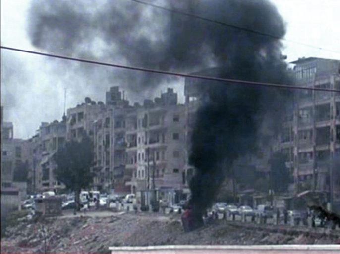 A handout image released by the official Syrian Arab News Agency (SANA) shows smoke billowing in the Aleppo district of Izaa where SANA said gunmen fanned out the area and opened fire at random in Syria's second largest city Aleppo on April 14, 2012. The UN Security Council unanimously passed its first resolution on the Syria crisis, allowing an advance party of ceasefire monitors