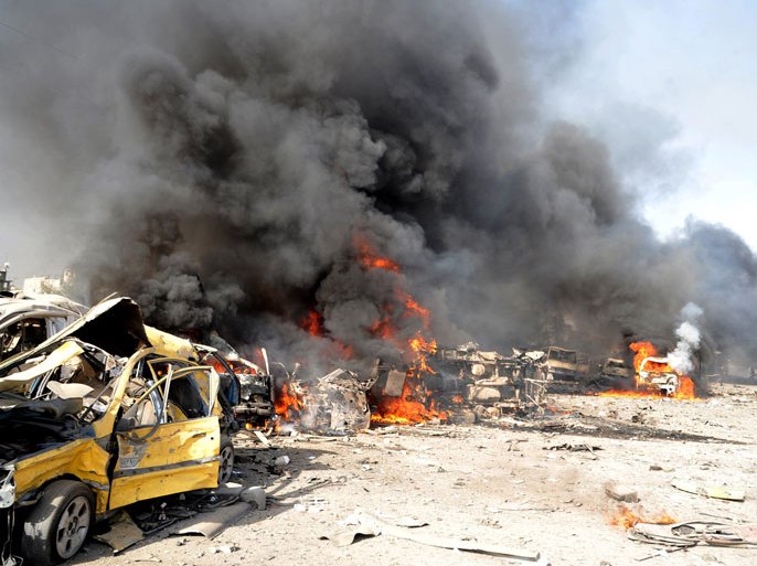 handout picture from the Syrian Arab News Agency (SANA) shows burning vehicles at the site of twin blasts in Damascus on May 10, 2012.