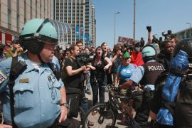 CHICAGO, IL - MAY 18: Police try to control protestors on outside the Prudential Building which houses the reelection headquarters for President Barack Obama during an impromptu demonstration that weaved its way through downtown on May 18, 2012 in Chicago, Illinois. This was the fifth day of protests in what is expected to be a full week of demonstrations as the city prepares to host the NATO Summit May 20-21. Scott Olson/Getty Images/AFP== FOR NEWSPAPERS, INTERNET, TELCOS & TELEVISION USE ONLY ==