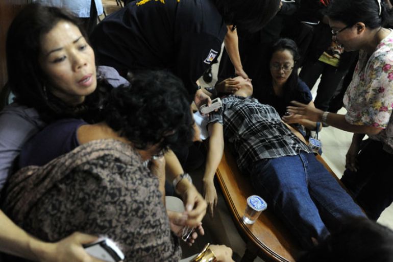 Indonesian relatives of passengers of the Russian Sukhoi Superjet 100 grieves while another collapse at Halim Perdanakusuma airport in Jakarta on May 10