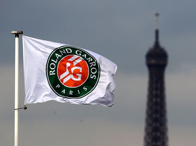 PARIS - MAY 26: The Eiffel Tower is seen in the background of a flag on day four of the French Open at Roland Garros on May 26, 2010 in Paris, France. (Photo by Clive Brunskill/Getty Images)