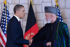 Afghan President Hamid Karzai (R) shakes hands with US President Barack Obama after signing a strategic partnership agreement on May 1, 2012