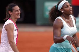 France's Virginie Razzano (L) reacts after winning over US Serena Williams during their Women's Singles 1st Round tennis match of the French Open tennis tournament at the Roland Garros stadium, on May 29, 2012 in Paris. AFP PHOTO / PATRICK KOVARIK
