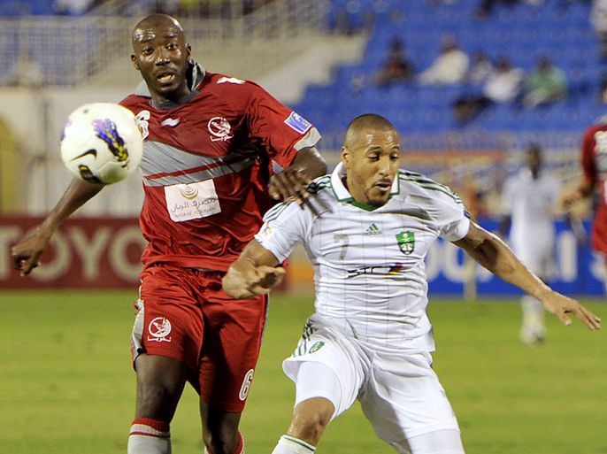 Lekhwiya's French defender Dame Traore (L) challenges Al-Ahli's Brazilian striker Victor Simoes during their AFC Champions League group C football match in the Saudi coastal city of Jeddah on May 1, 2012. AFP PHOTO/AMER HILABI